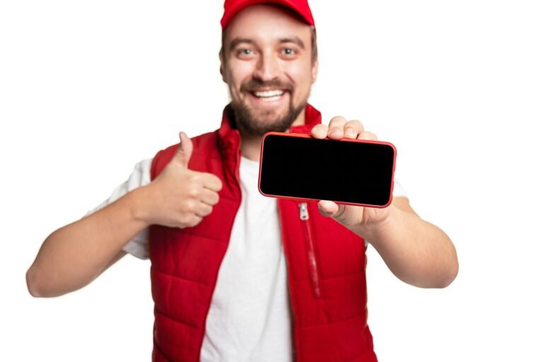 Cheerful delivery man recommending app on smartphone